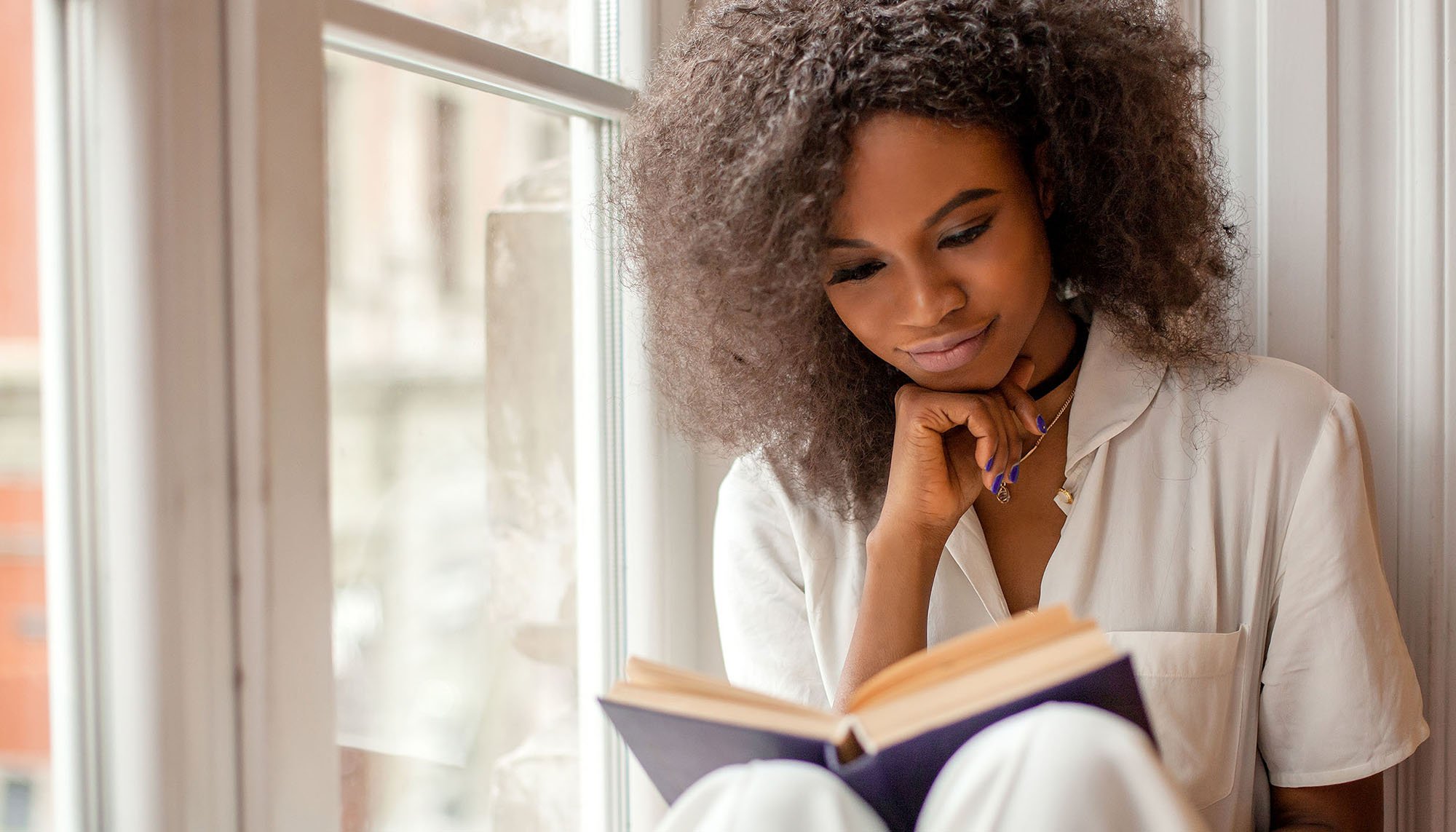 african woman reading book