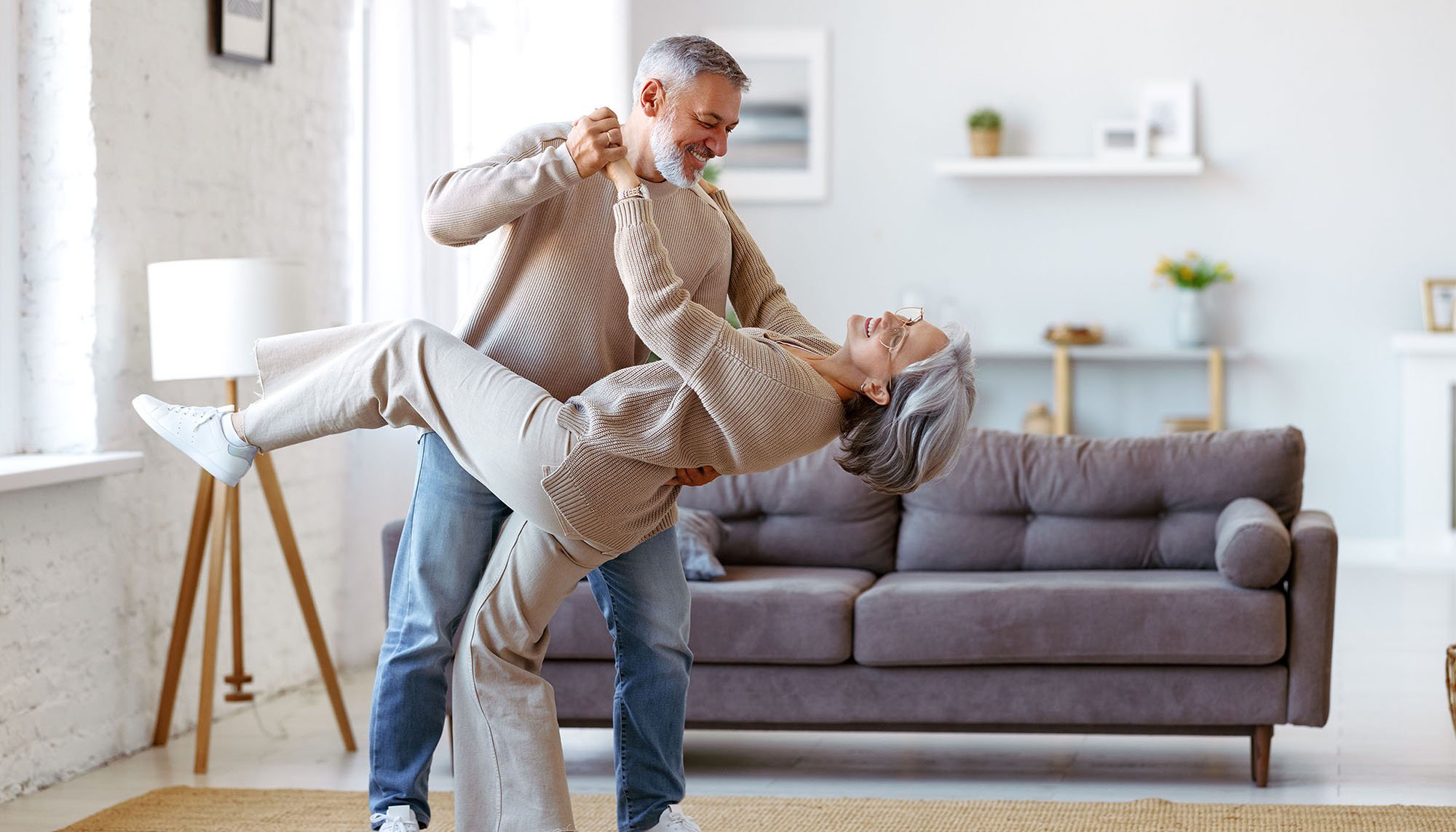 older couple dancing in living room