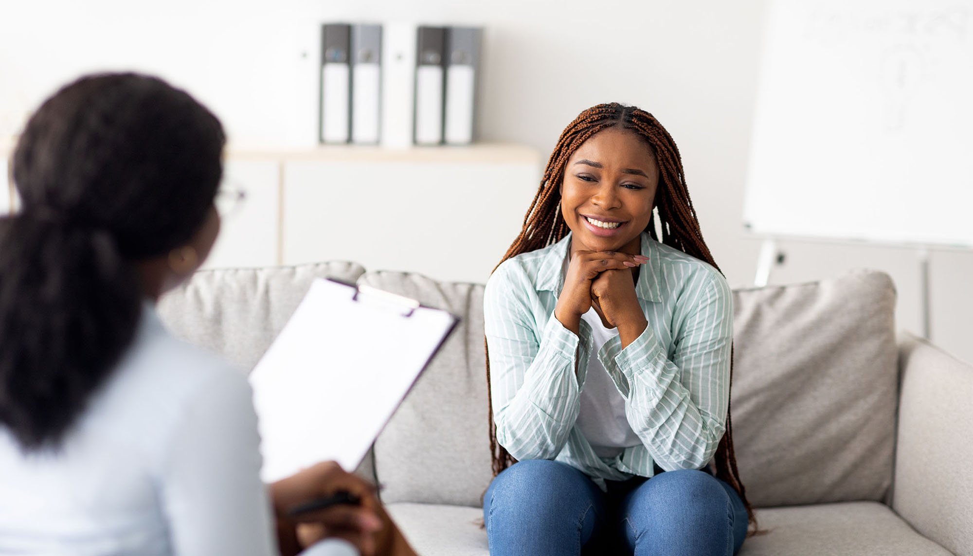 african woman consulting with doctor in office