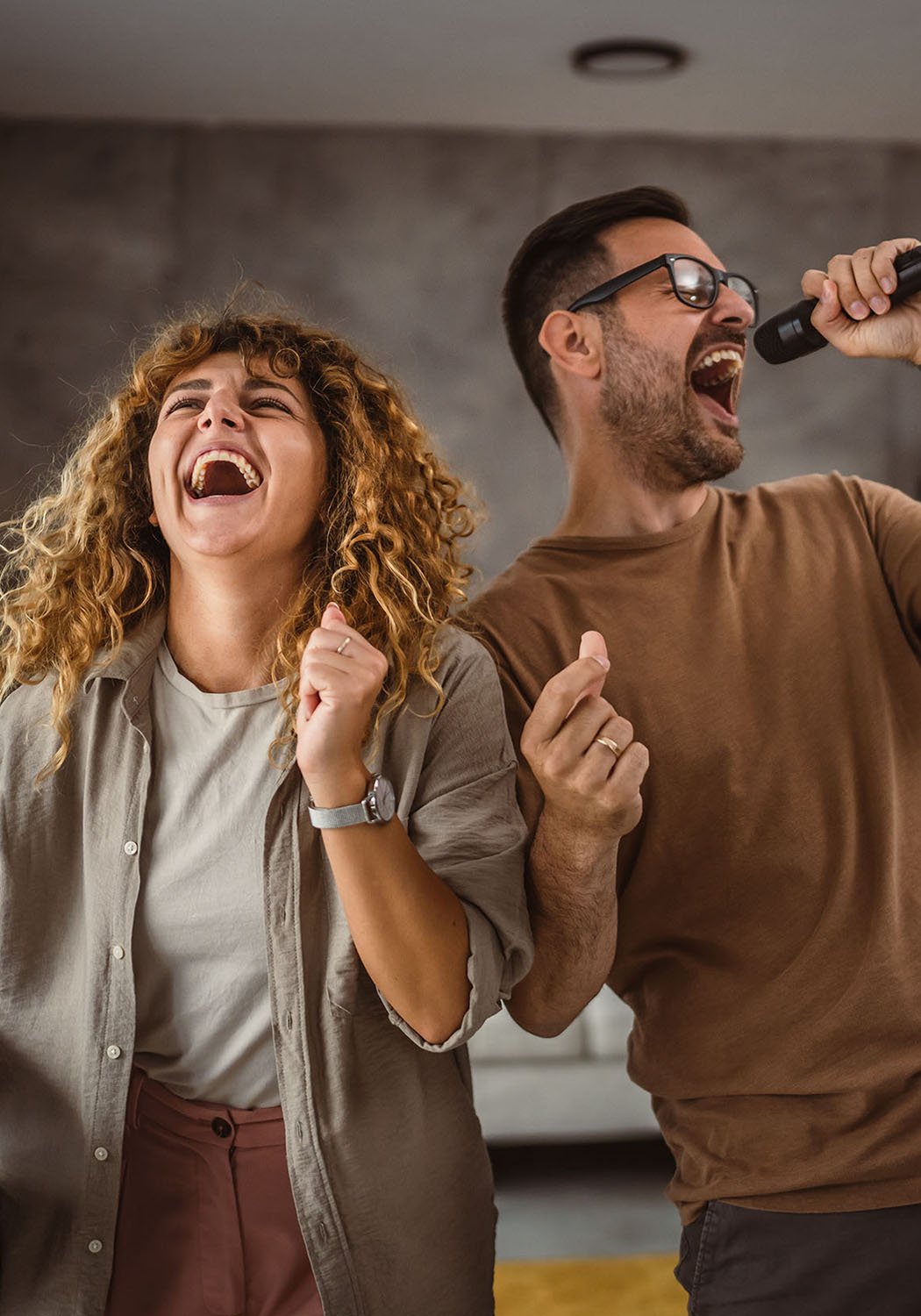 couple singing with microphone