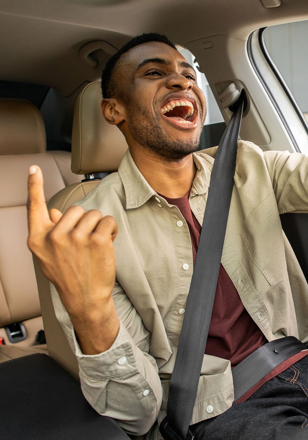 man singing in the car