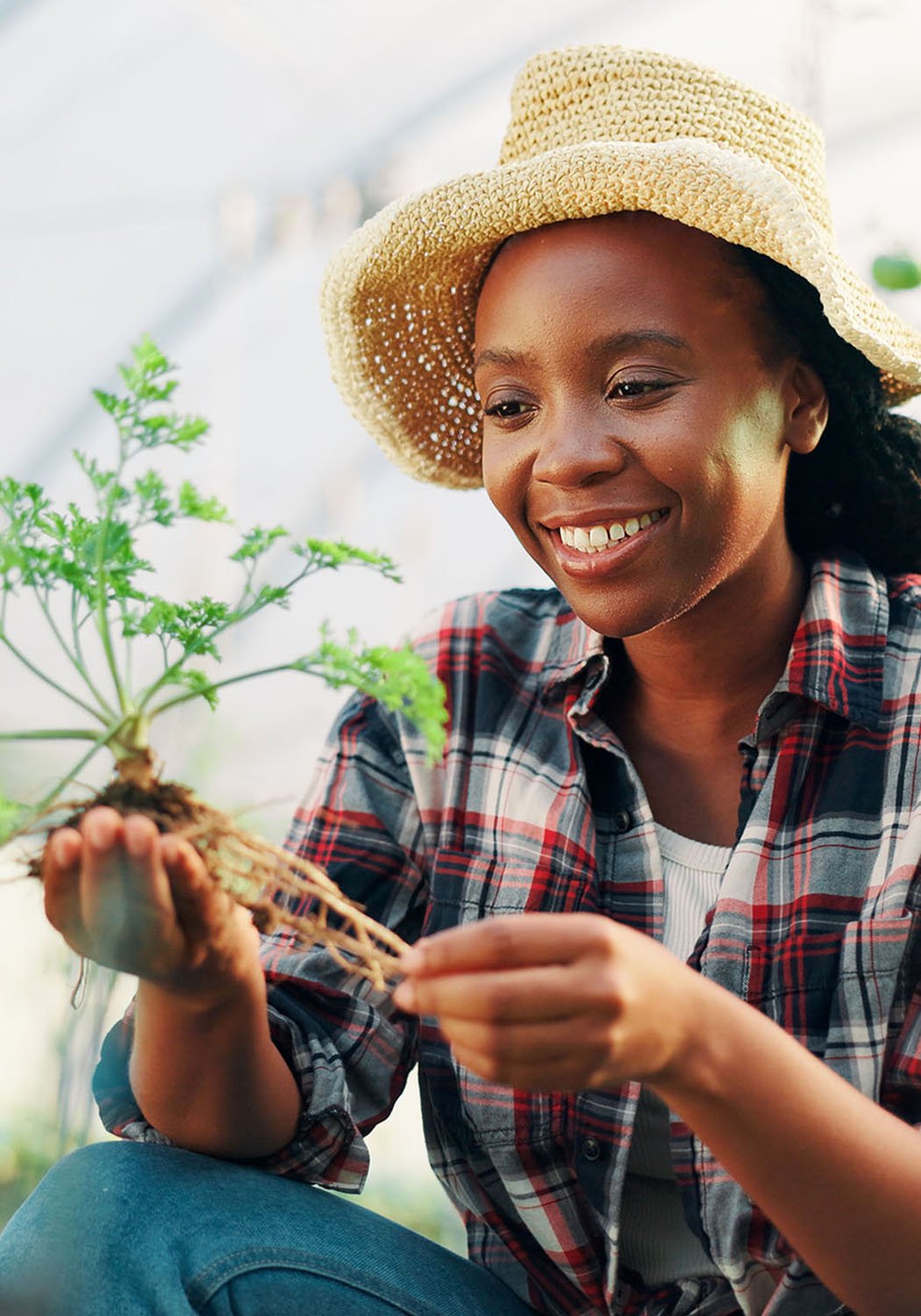woman smiling holding plant