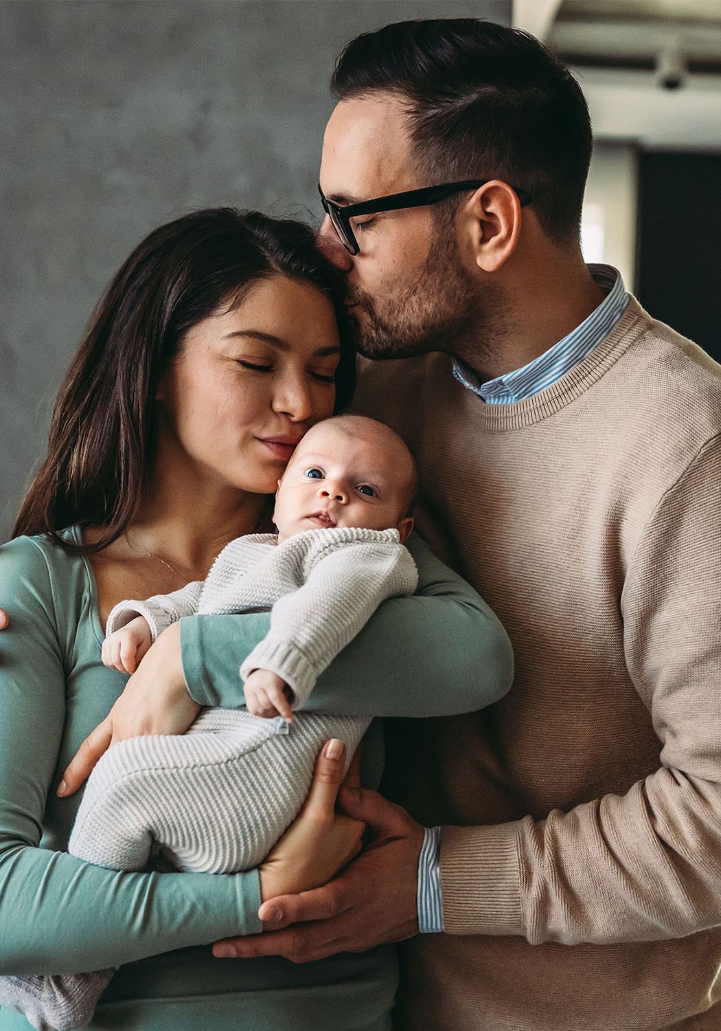 mother and father holding infant child