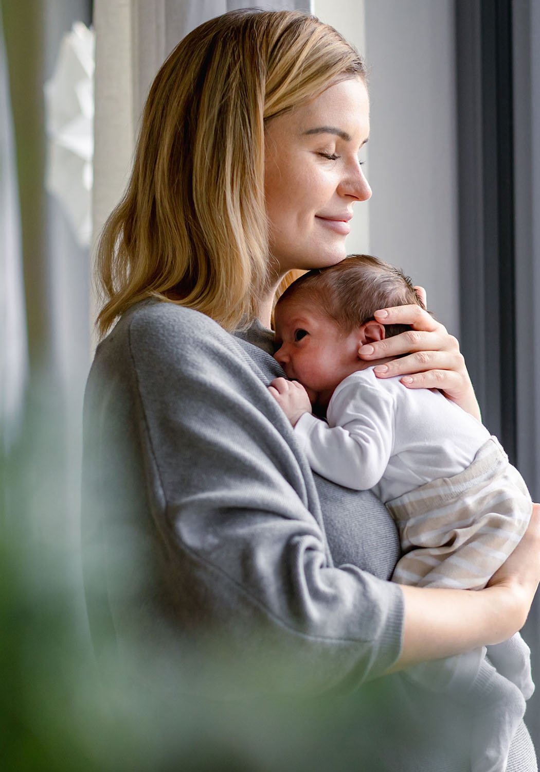 mother holding infant child