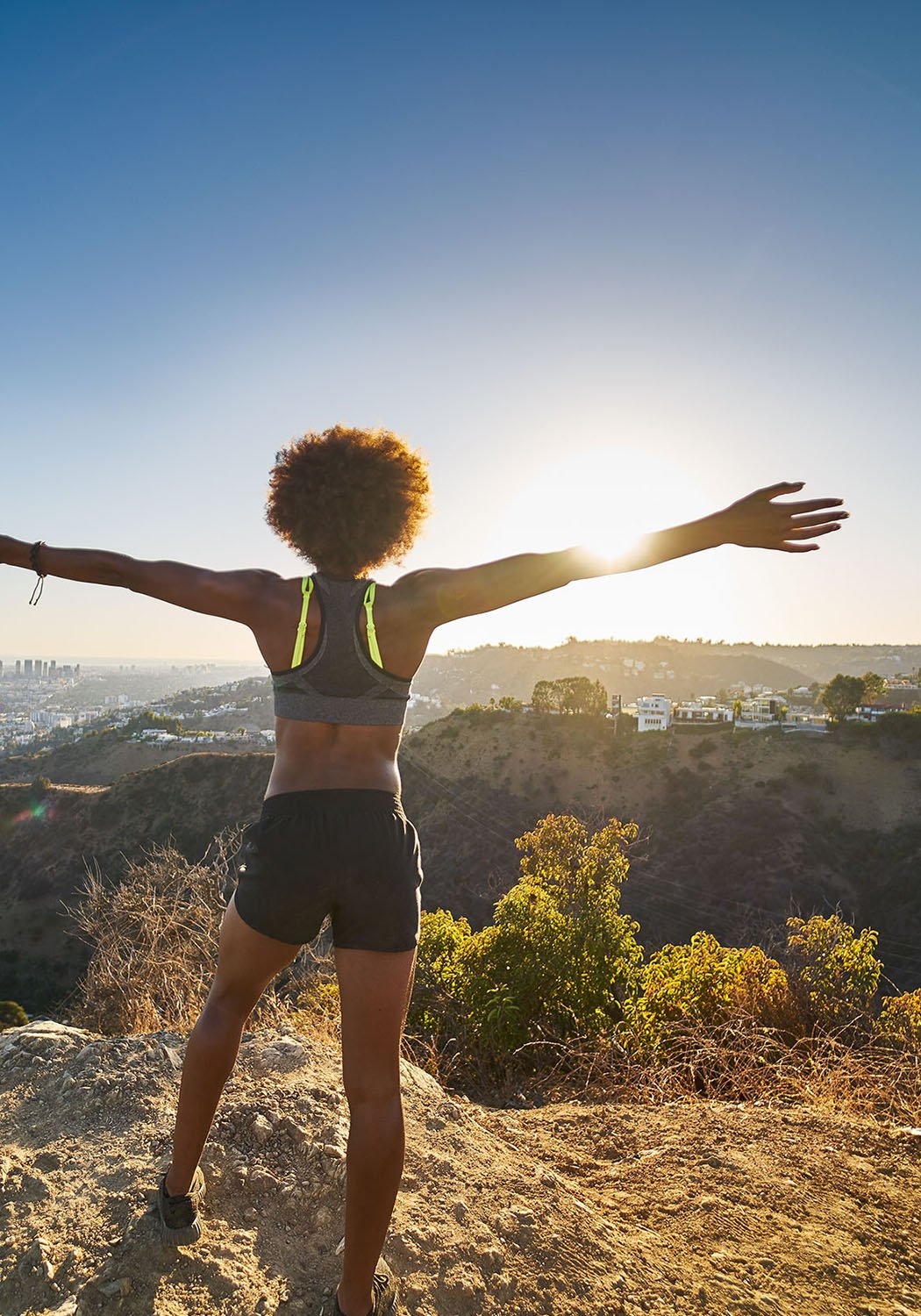 woman runner with arms out stretched
