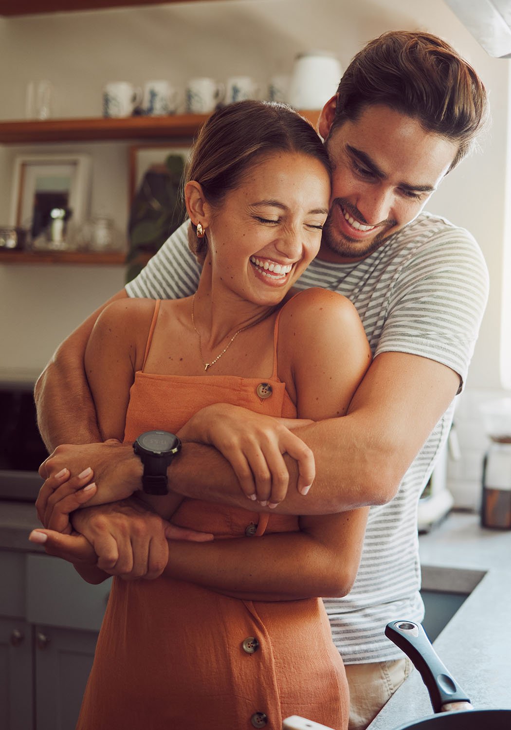 couple hugging while cooking